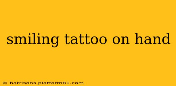 smiling tattoo on hand